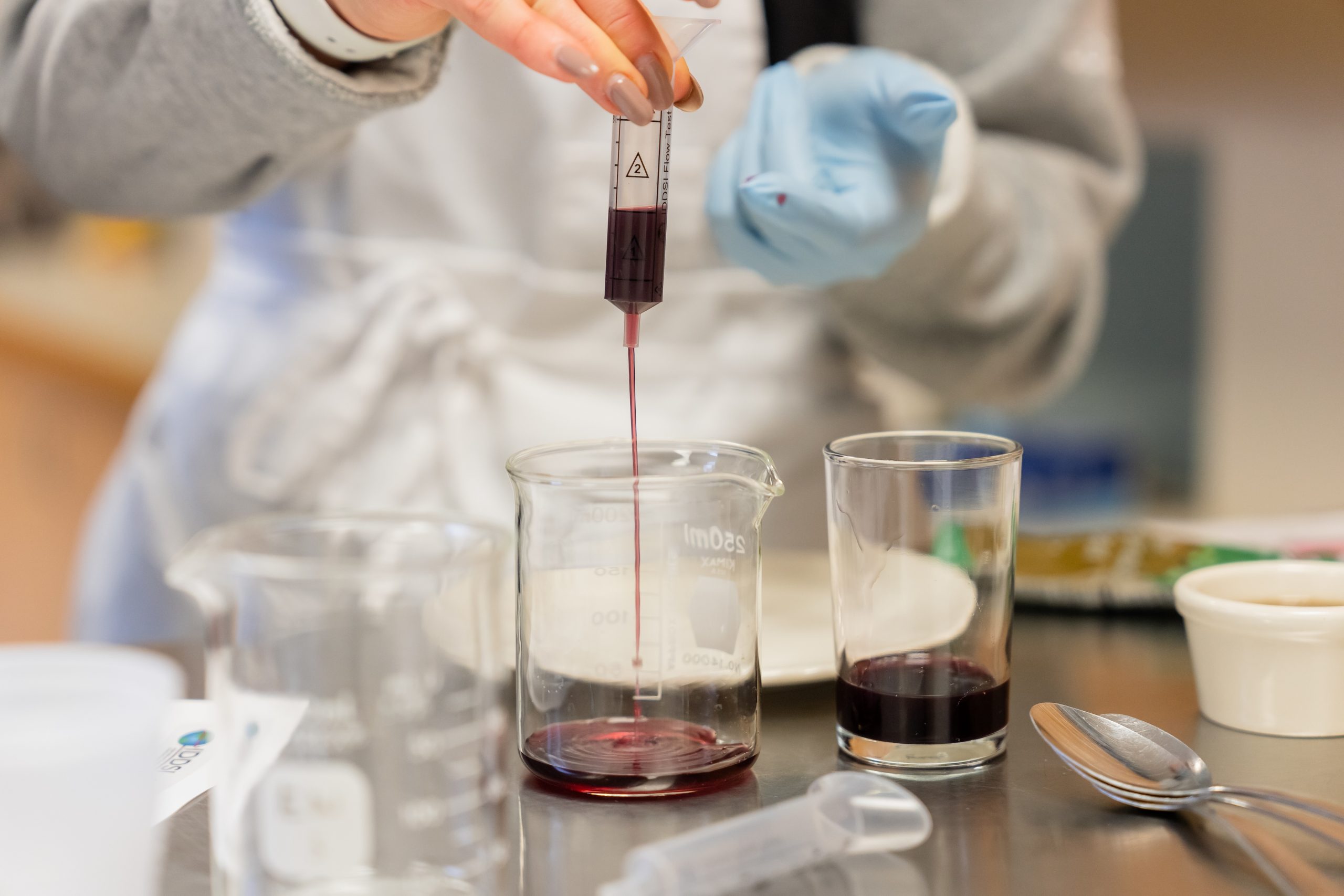 Photo of person putting food in beaker